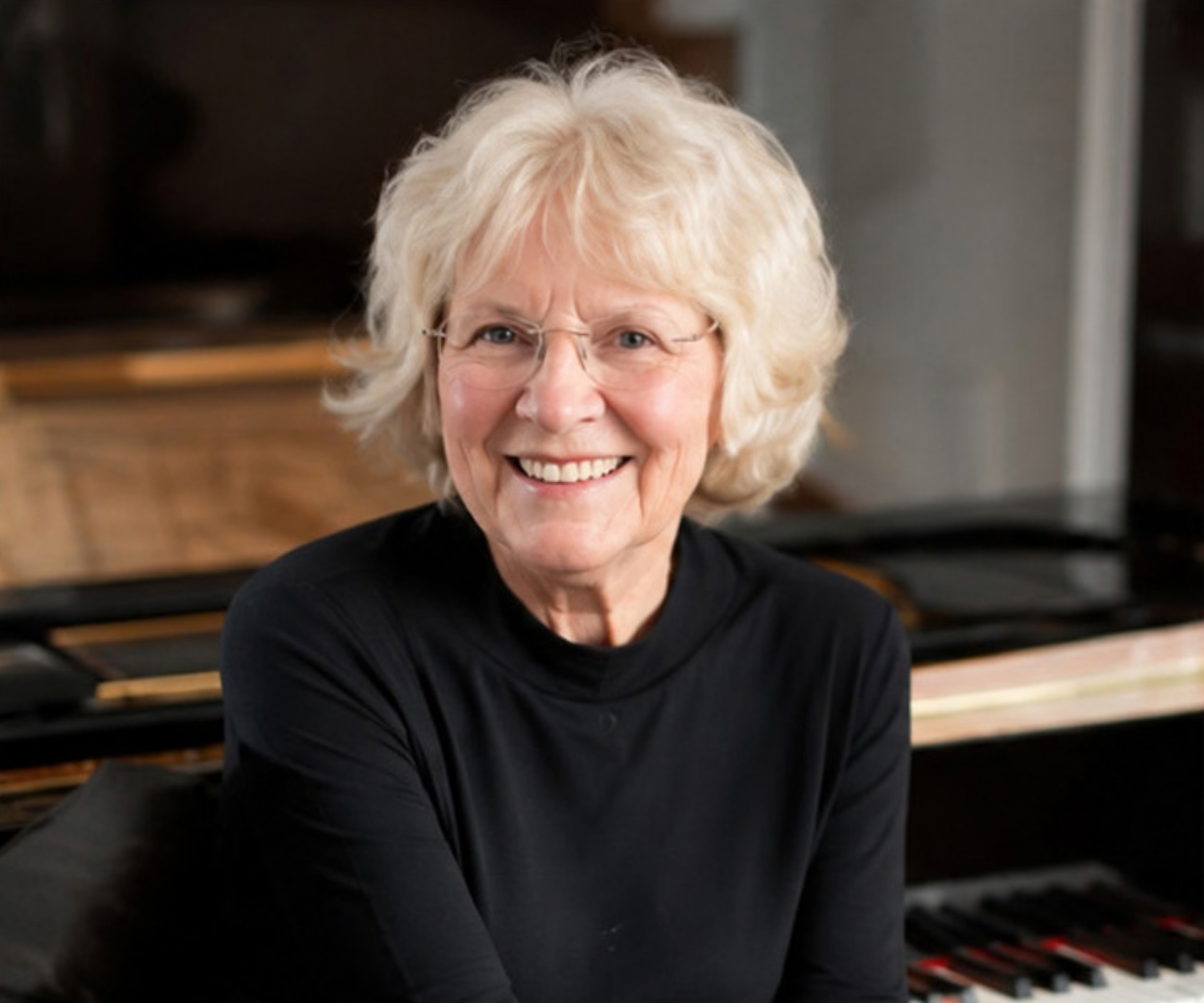 Susan Griesdale seated at her piano